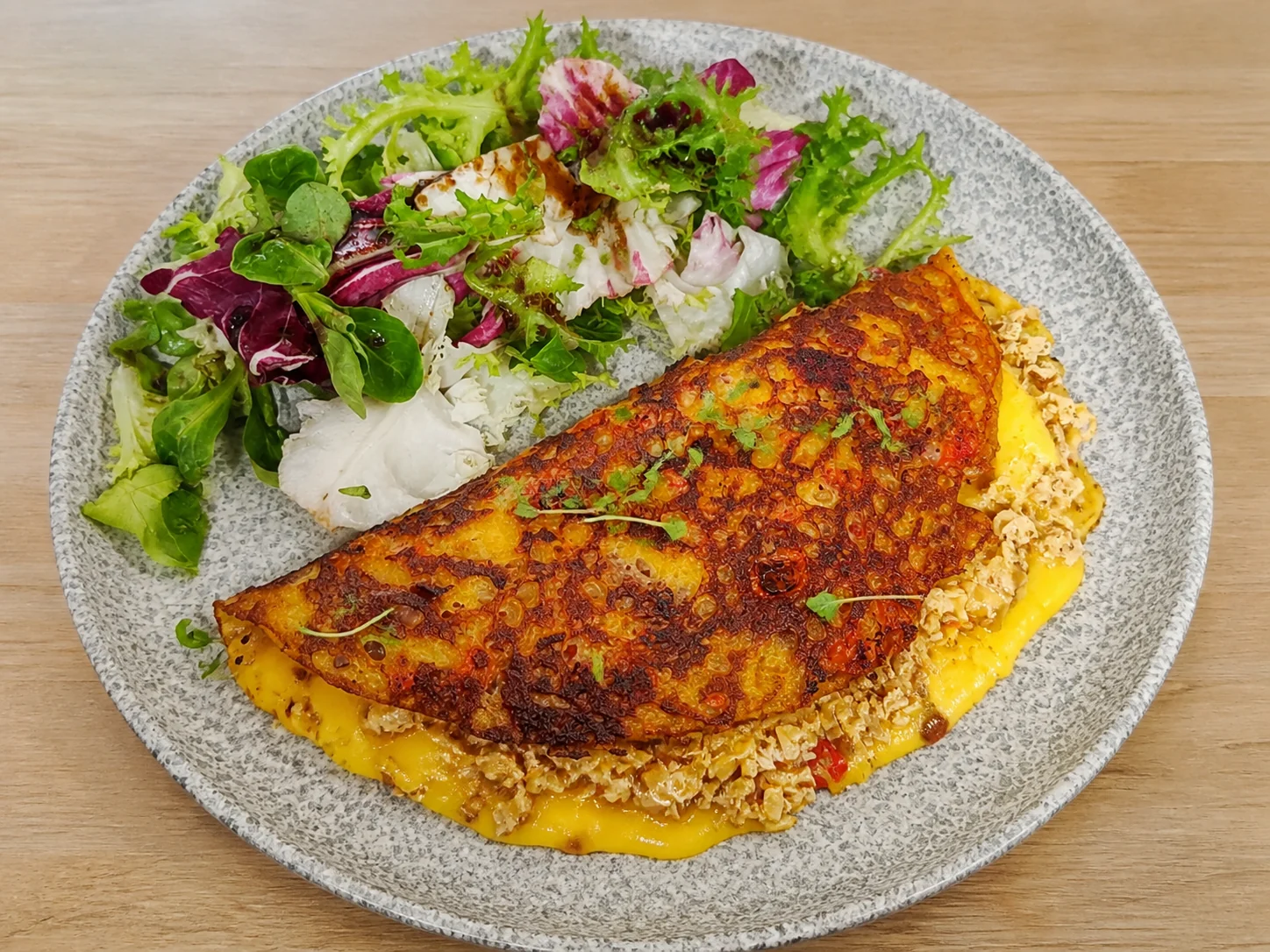 Vegan cheese and tofu bacon oomelette with mixed leaf salad
